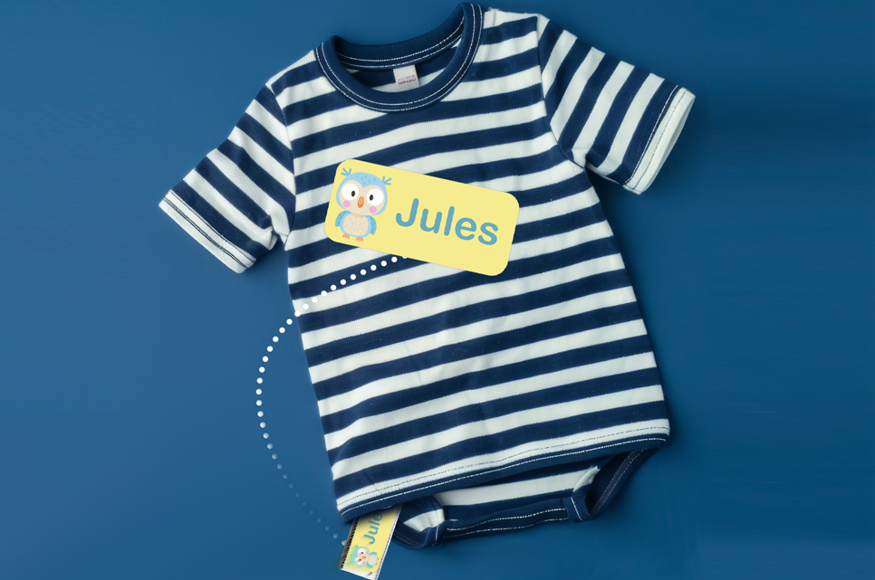 Dark grey school shorts with a blue name label on the care label.