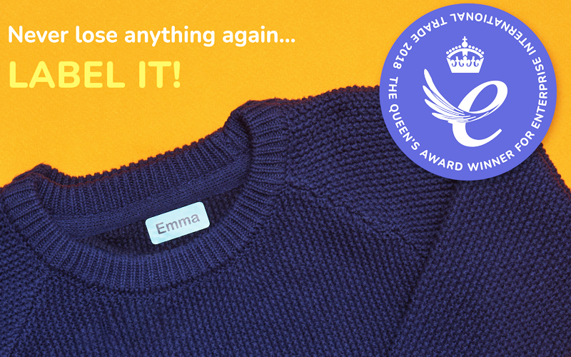 Navy blue jumper with My Nametags label attached and a the Queen's award logo on an organge background